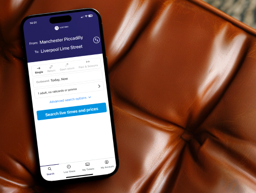 Phone resting on a dark beige chair with the Northern Rail app displayed on the screen.