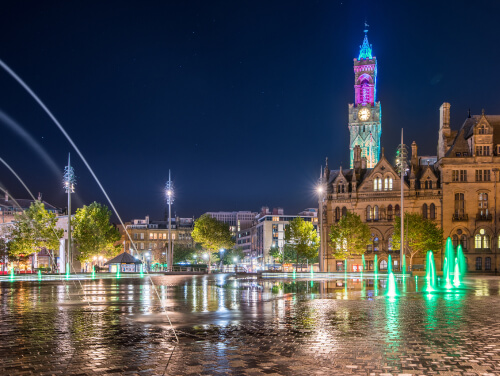 Bradford city centre illuminated by lights at night