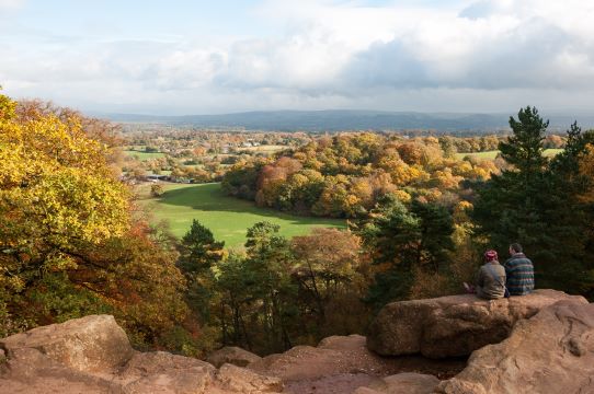 Couple sat looking at view of Alderley Edge