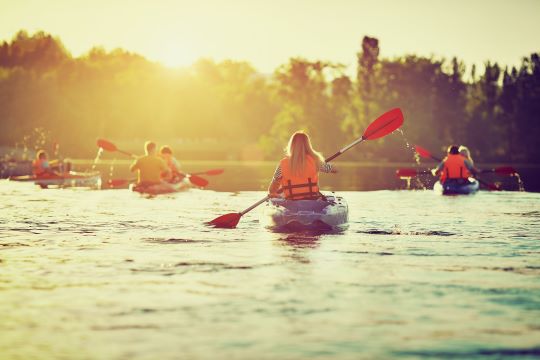 Group of people kayaking on river