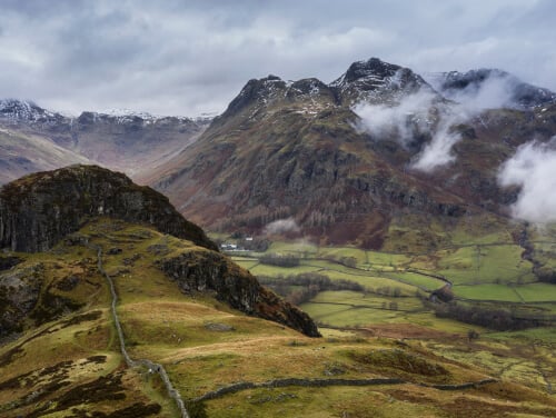 Cloudy view of Langdale Pikes in the Lake District with green mountains