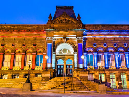 The front of Leeds City Museum illuminated in the darkness