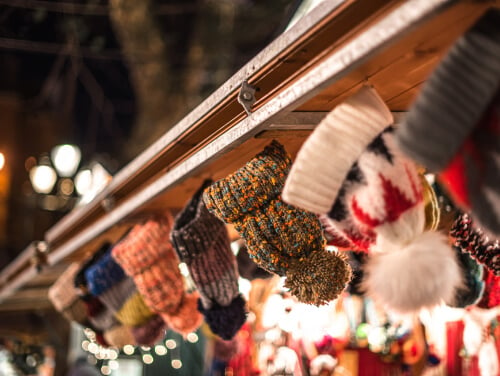 Close-up of woolly hats at a Christmas market stall