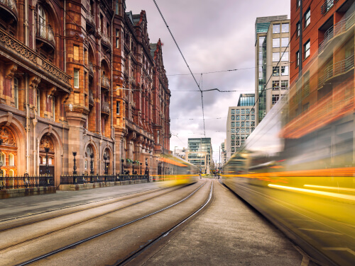 Trams speeding by on Manchester street