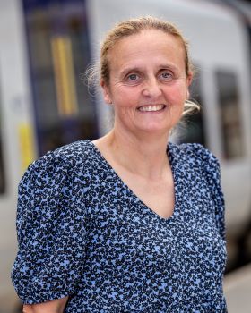 Professional image of Rebecca Styles, wearing a blue spotted dress