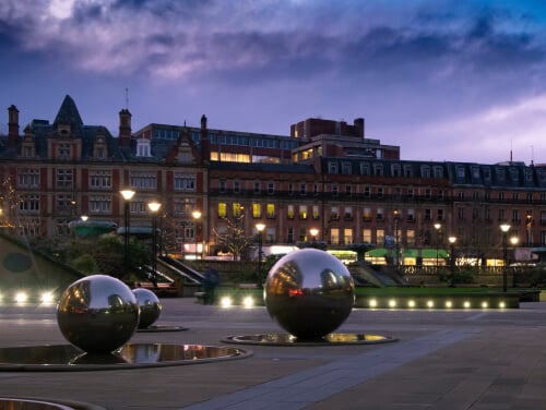 Sheffield city centre with metal statue balls in the centre of the image