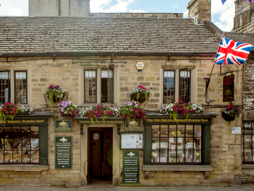 Exterior of the Old Original Bakewell Pudding Shop in the Peak District with a Union Jack flag flying outside