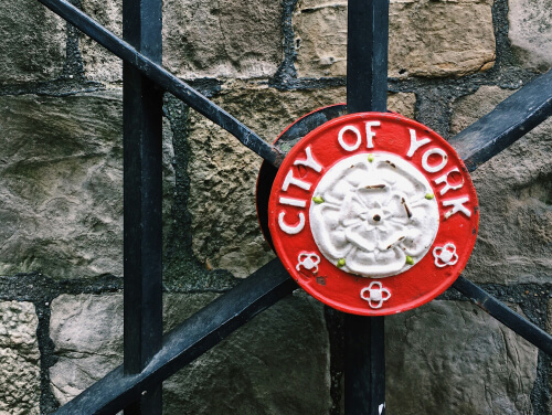 A gate with the City of York seal on it.