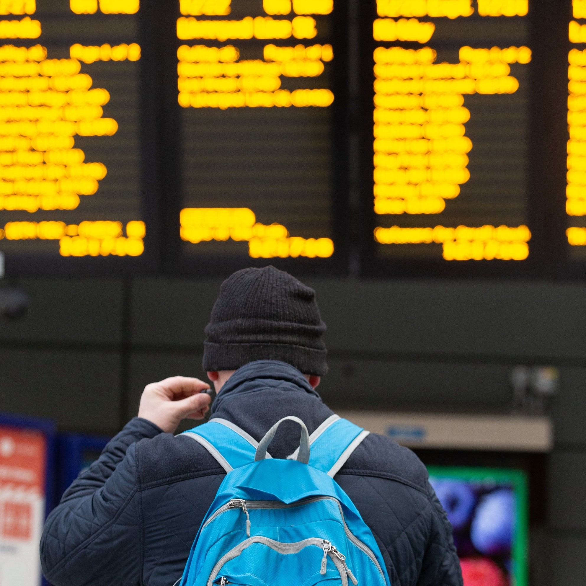 Image shows customer at departure screens