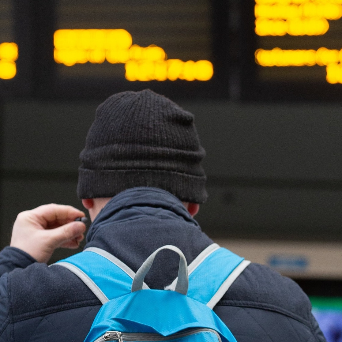 Image shows customer at departure screens cropped