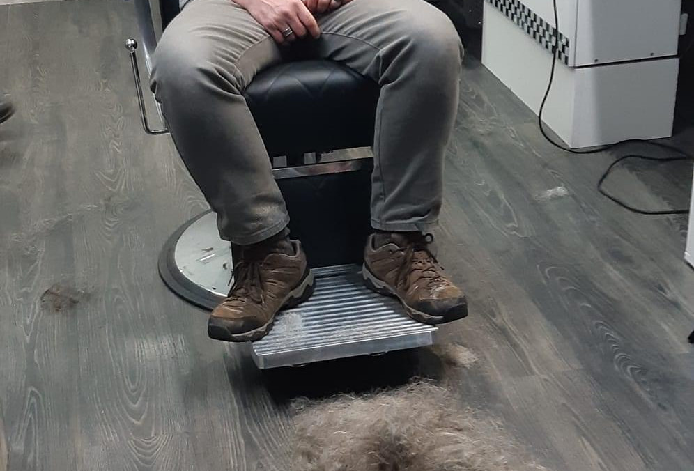 danny-with-his-head-and-beard-shaven-next-to-the-barbers-chair-is-a-pile-of-his-hair