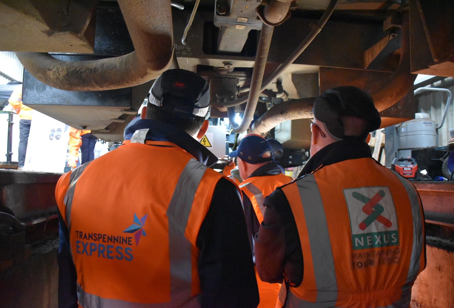 industry-colleagues-looking-underneath-the-train-at-the-new-technolgy