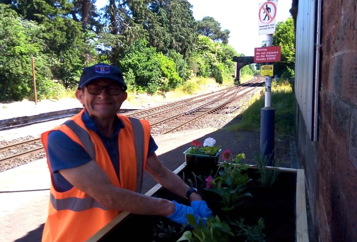 this-image-shows-a-volunteer-at-dalston-station