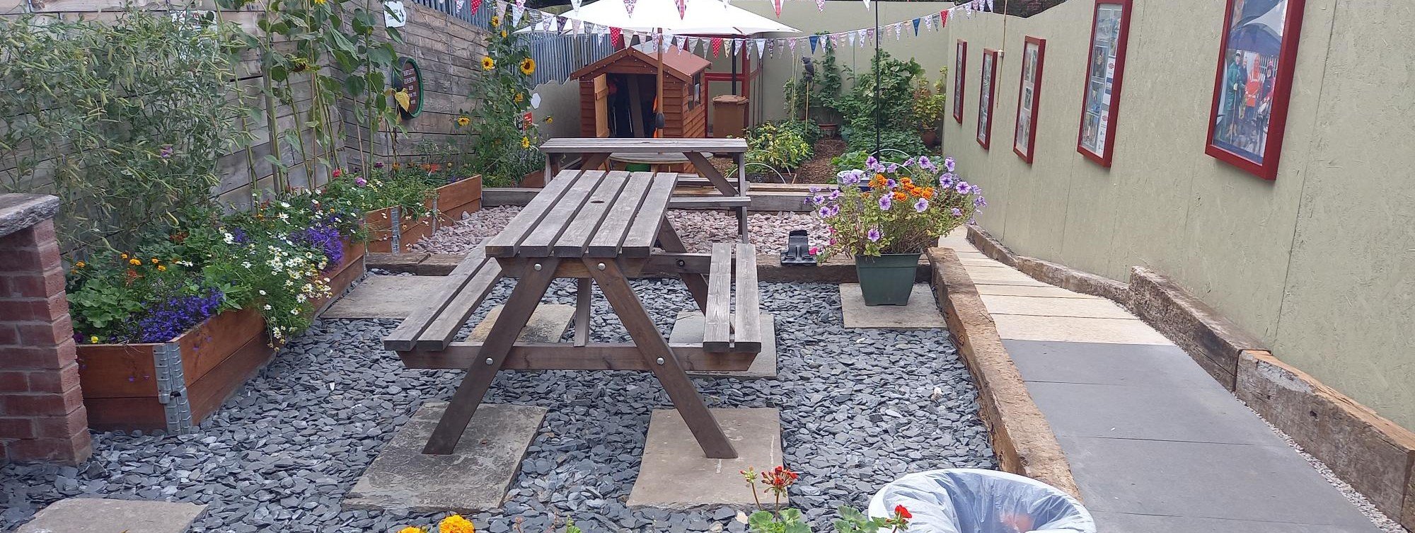 barrow-memorial-garden-with-planters-a-picnic-bench-and-colourful-flowers