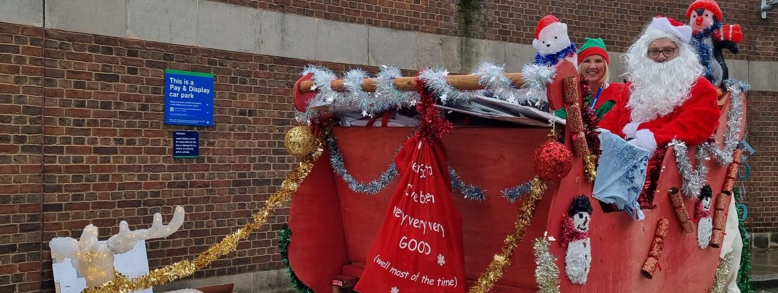 santa-and-his-elf-in-a-sleigh-made-by-northern-colleagues