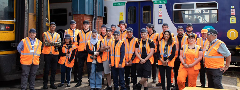 this-image-shows-colleagues-and-students-at-neville-hill-depot-in-front-of-a-northern-train