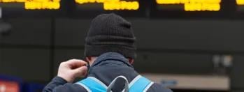 Image shows customer at departure screens cropped 3cyua-glsfv-zp6v9-p72x3-n1hm0