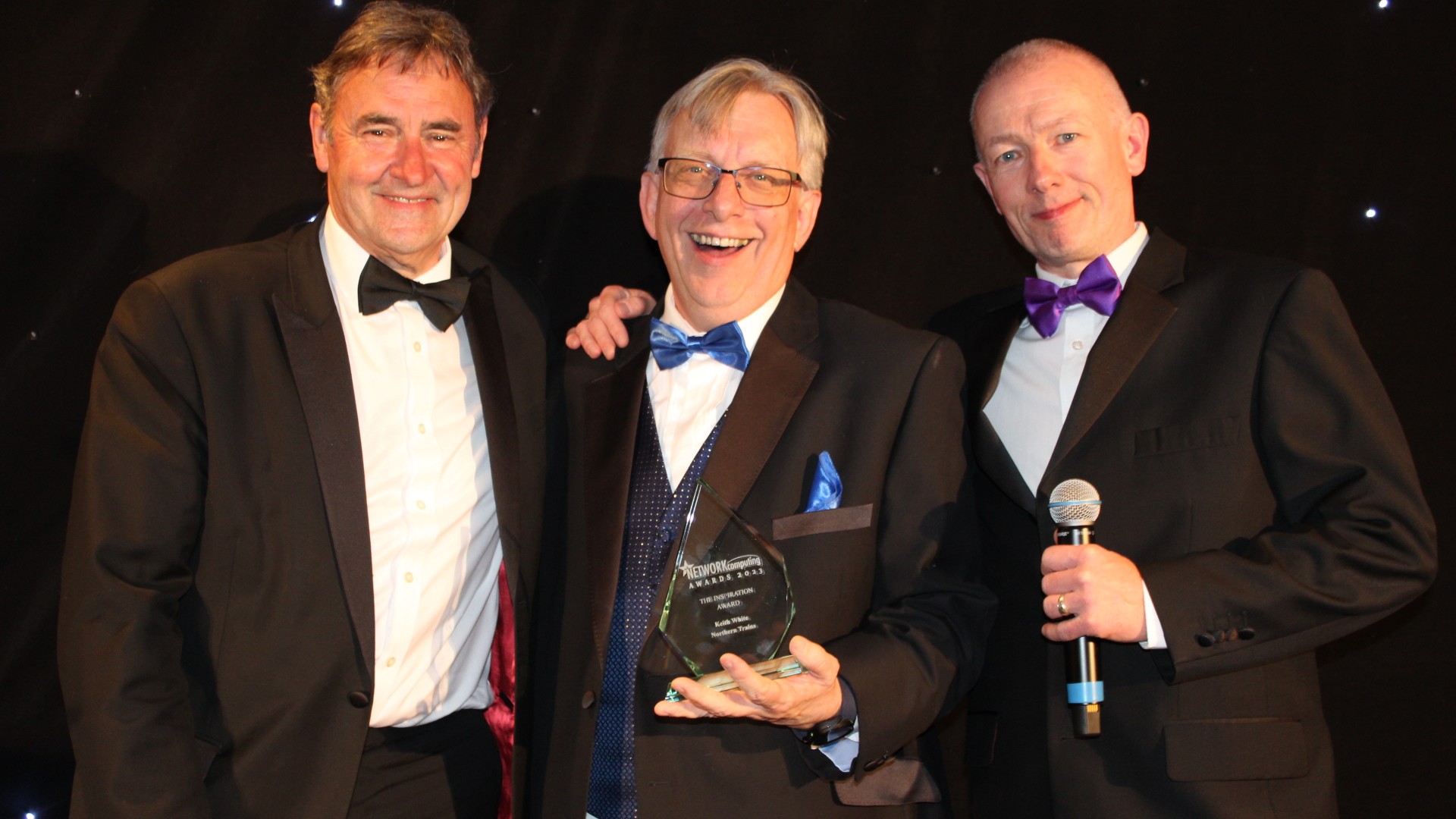 Image shows Keith White (centre) picking up his Inspiration Award