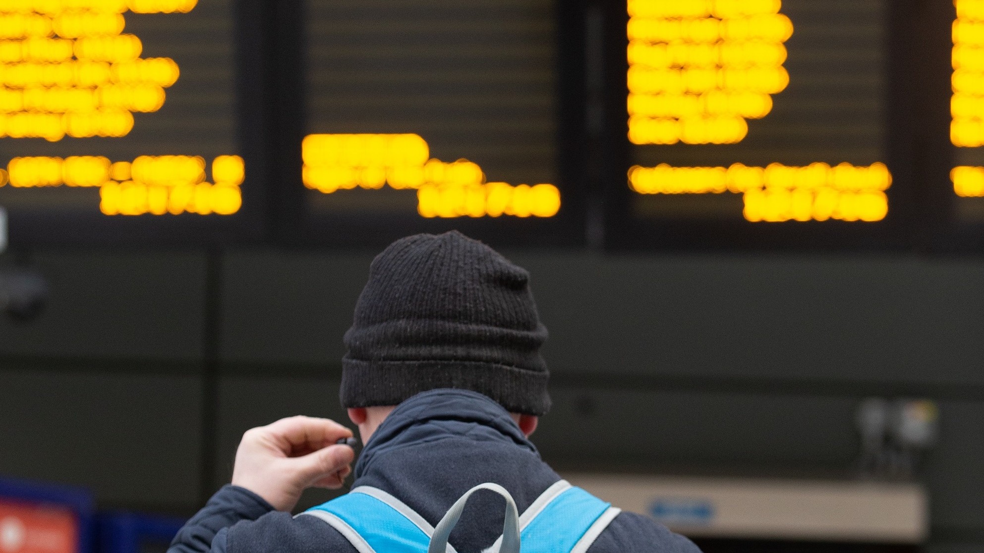 Image shows customer at departure screens