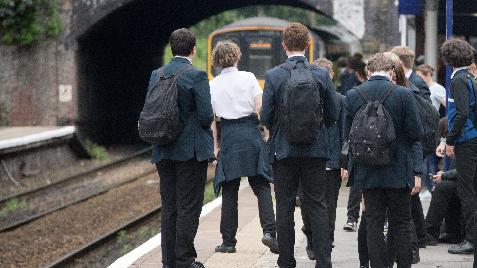 Image shows schoolchildren waiting arrival of a Northern service
