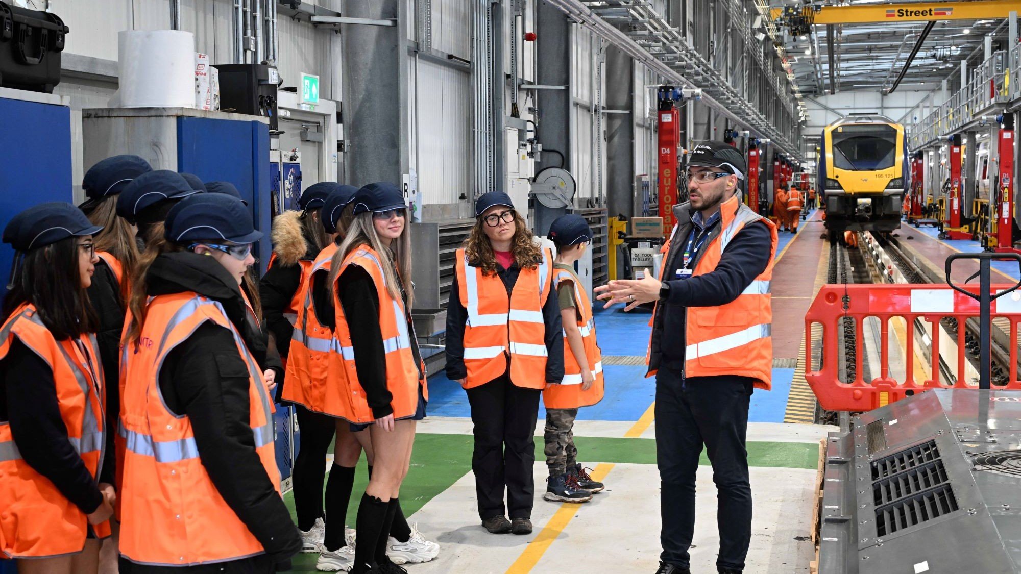 Image shows schoolgirls on a tour of Newton Heath TrainCare Centre