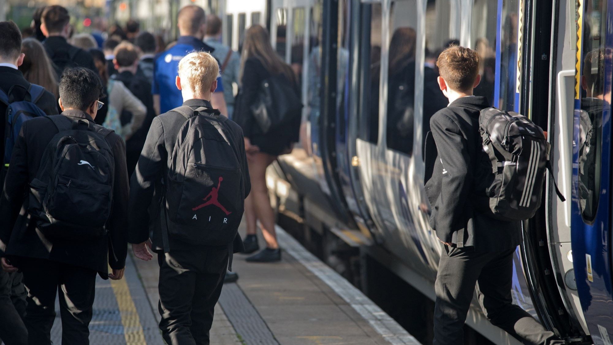 Image shows secondary school students commuting to school