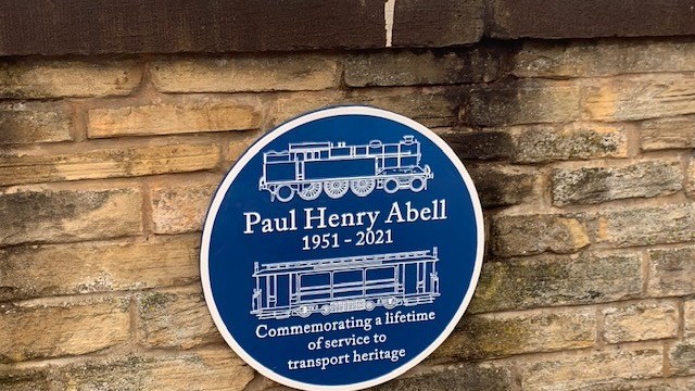 The blue plaque at Ashburys station commemrating Paul Abell