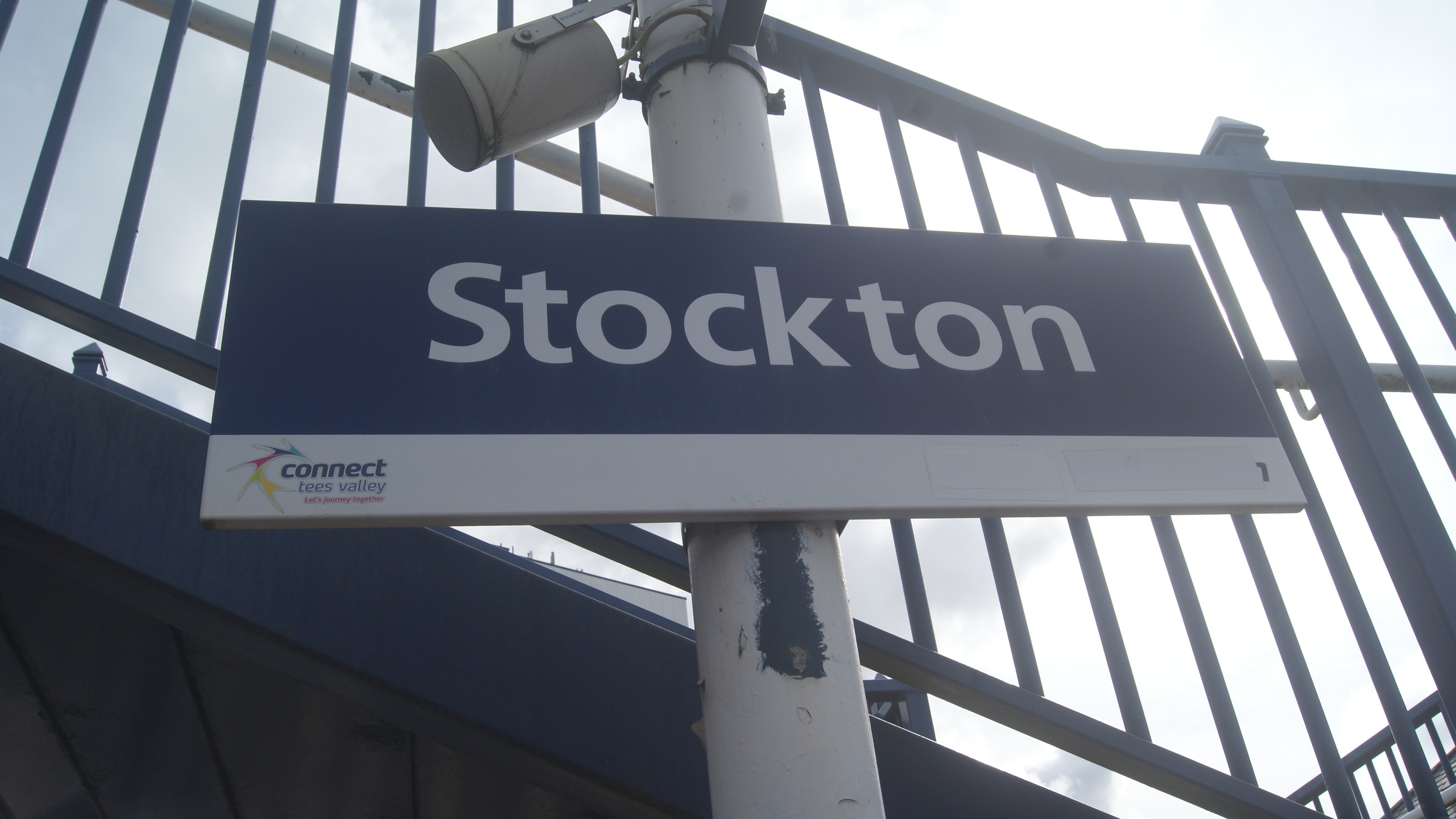 This image shows the blue and white Stockton station sign